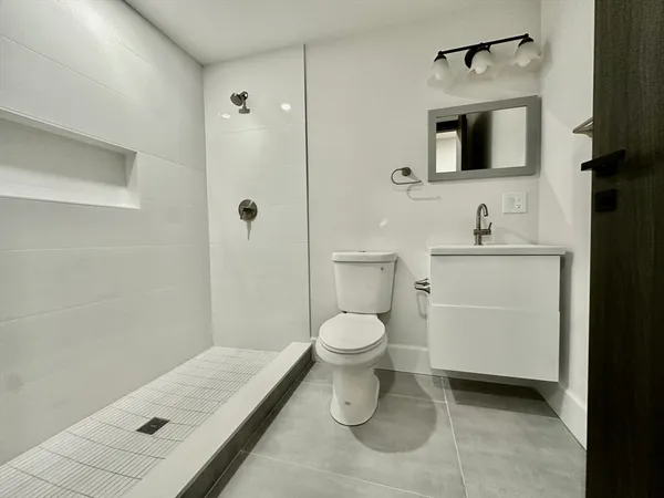 a bathroom with a toilet sink and shower