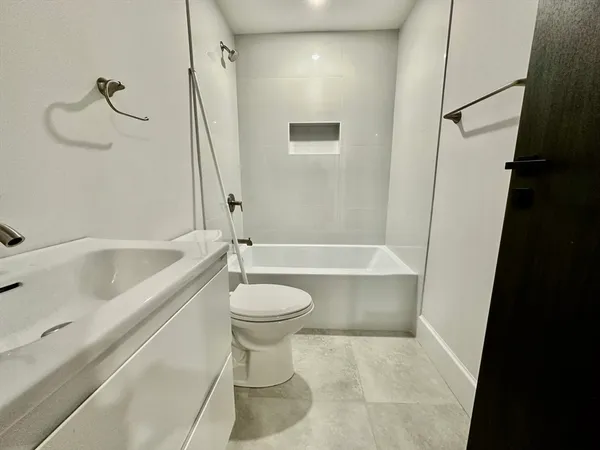 a bathroom with a bathtub a toilet and a shower