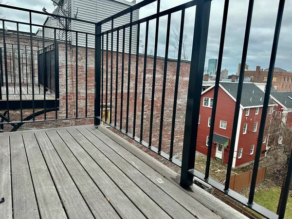 a view of balcony with wooden floor