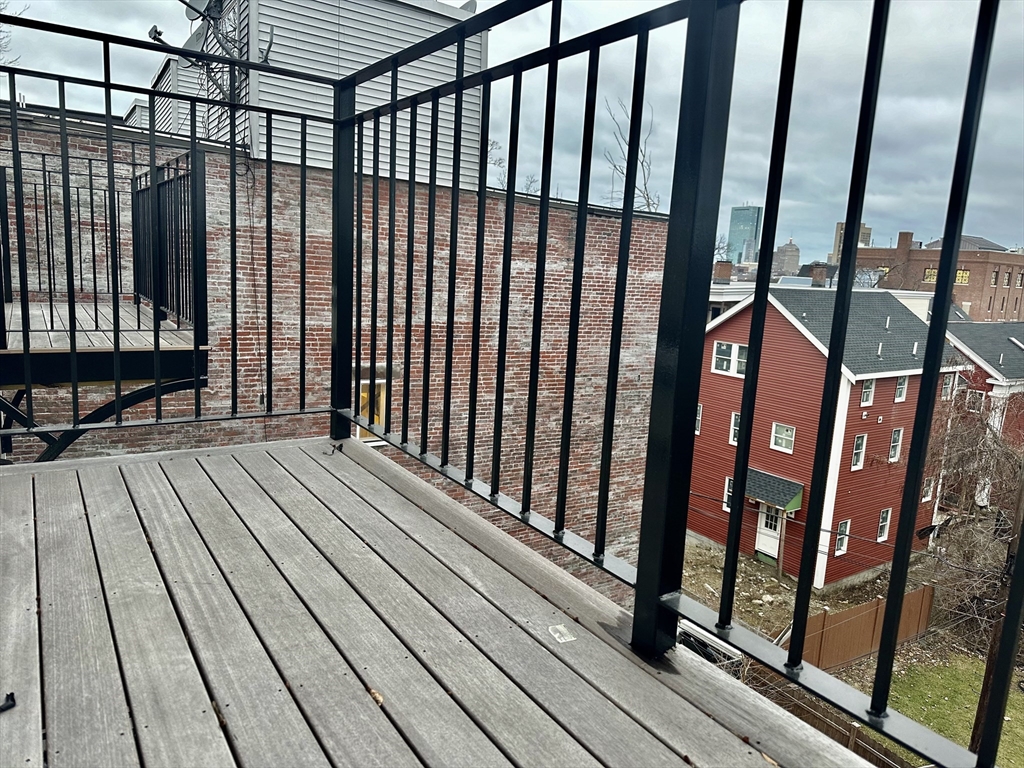 100 Mt Pleasant Avenue, Unit 4 Boston, MA 02119 - Photo 15 of 15 a view of balcony with wooden floor