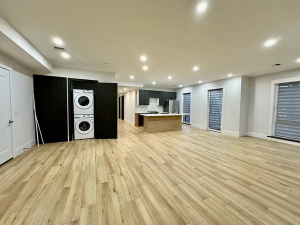 a view of empty room with a kitchen