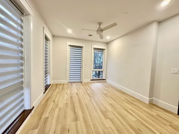 a view of wooden floor and windows in a room