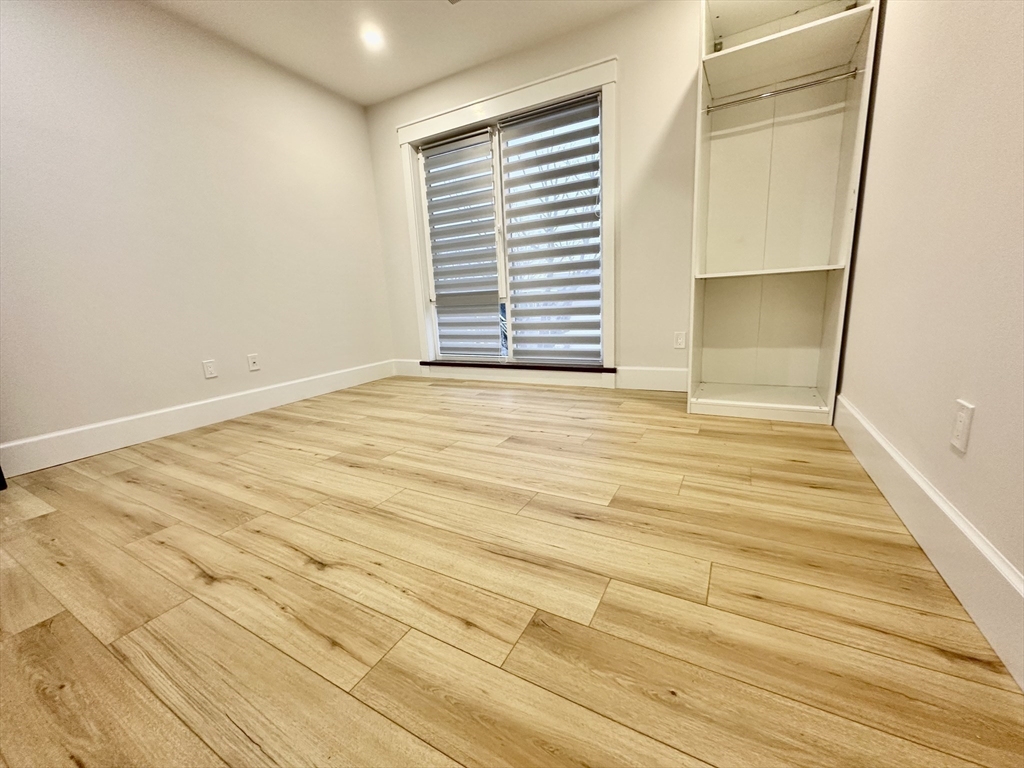 100 Mt Pleasant Avenue, Unit 4 Boston, MA 02119 - Photo 8 of 15 a view of an empty room with a window