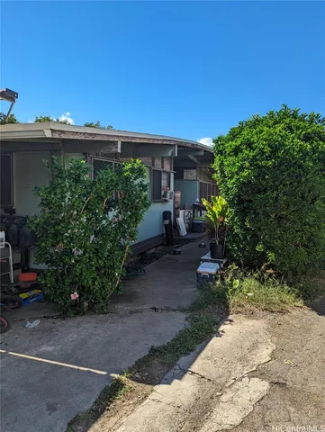 a view of a back yard with flower plants and water view