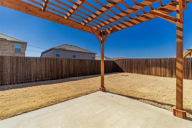 a backyard of a house with wooden fence