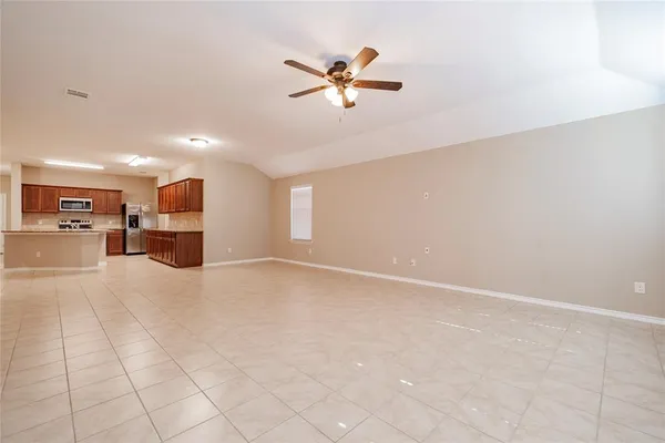 a view of a livingroom with furniture and a ceiling fan