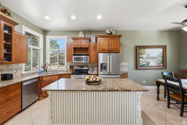 1683 North Main Street Centerville, UT 84014 - Photo 5 of 37 Kitchen featuring a central island with a granite countertop and beadboard paneling