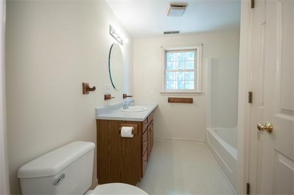 8 Aaron Drive Topsfield, MA 01983 - Photo 20 of 26 a bathroom with a toilet sink vanity tub and mirror