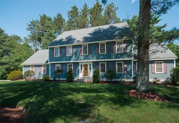 8 Aaron Drive Topsfield, MA 01983 - Photo 3 of 26 a front view of a house with a garden and trees