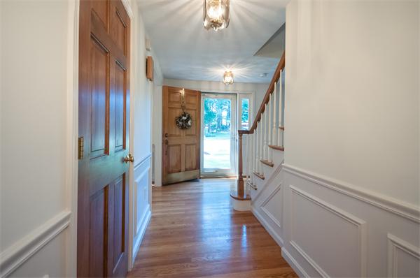 8 Aaron Drive Topsfield, MA 01983 - Photo 5 of 26 a view of hallway with stairs and wooden floor