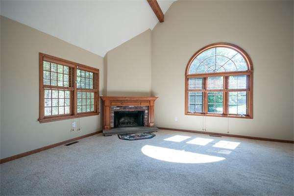 8 Aaron Drive Topsfield, MA 01983 - Photo 7 of 26 an empty room with windows fireplace and windows