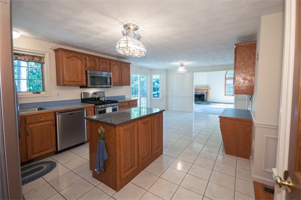 8 Aaron Drive Topsfield, MA 01983 - Photo 8 of 26 a kitchen with stainless steel appliances granite countertop a stove top oven a sink dishwasher and a refrigerator