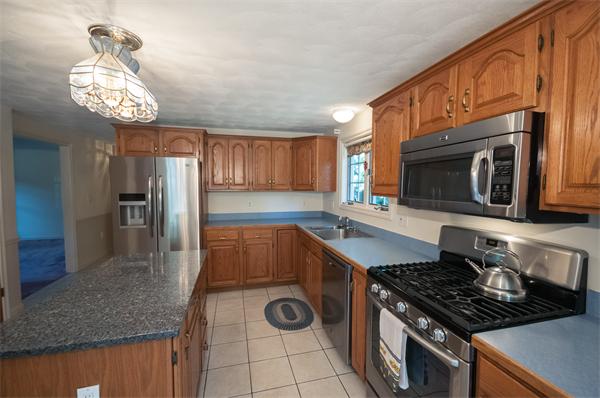8 Aaron Drive Topsfield, MA 01983 - Photo 10 of 26 a kitchen with stainless steel appliances granite countertop a stove and a sink
