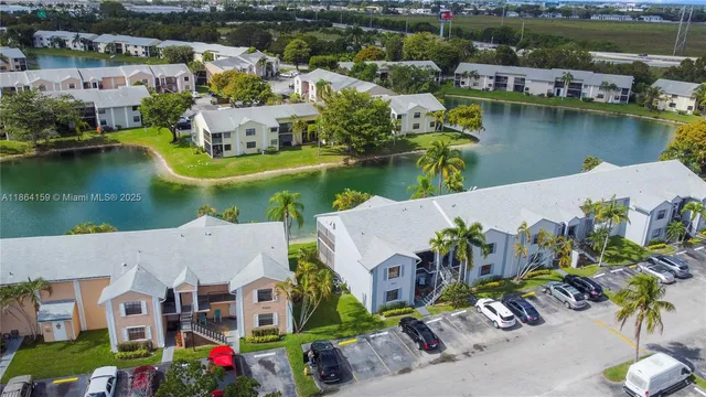 an aerial view of residential houses with outdoor space and lake view