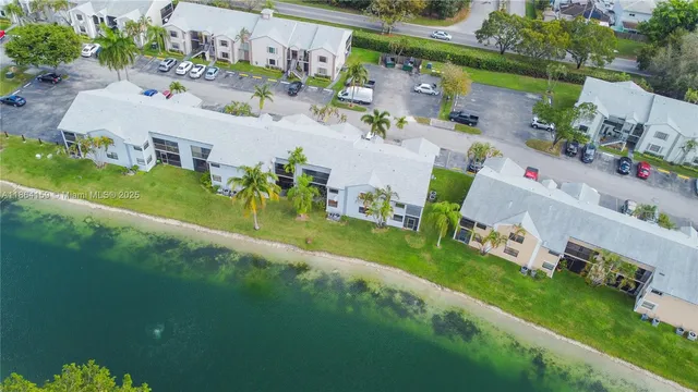 an aerial view of a house with outdoor space pool seating area and yard