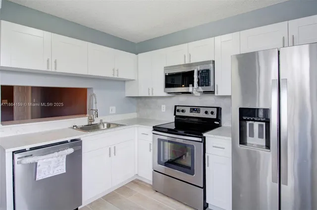 a kitchen with a stove microwave and refrigerator