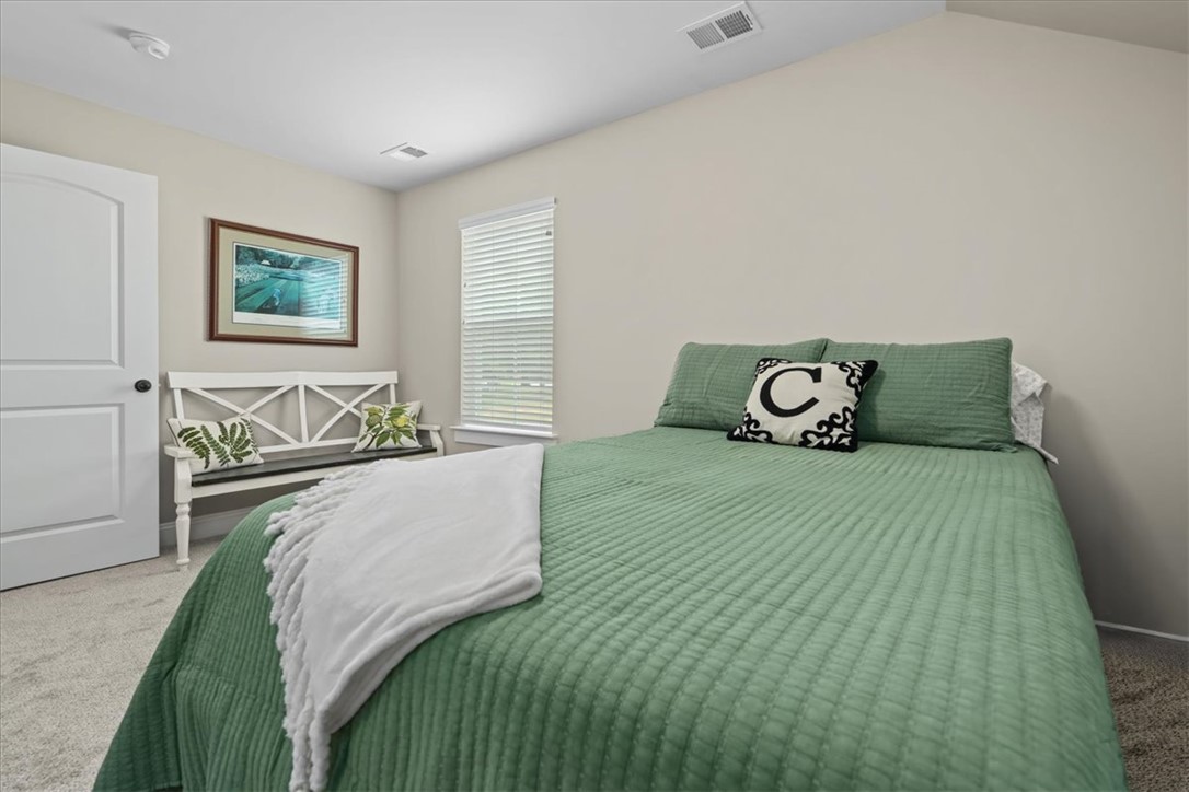 6834 Midway Road Pelzer, SC 29669 - Photo 39 of 50 This inviting bedroom features soft carpeting and a window with blinds, creating a comfortable and private retreat.