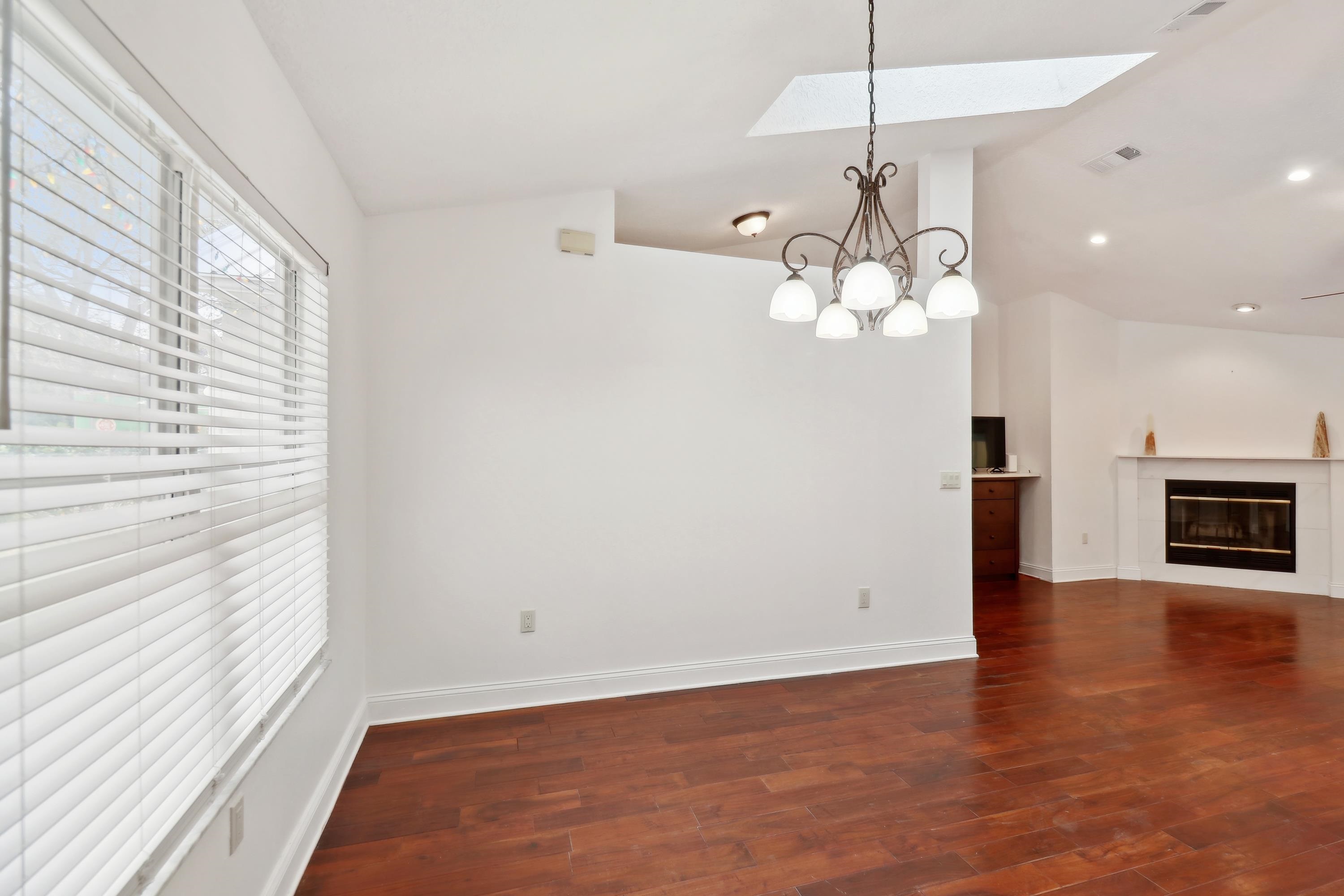240 Jasmine Road St. Augustine, FL 32086 - Photo 11 of 30 an empty room with wooden floor chandelier and windows