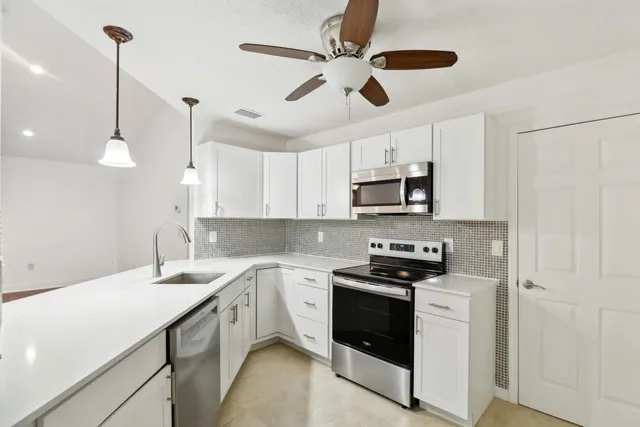a kitchen with stainless steel appliances a stove sink and refrigerator
