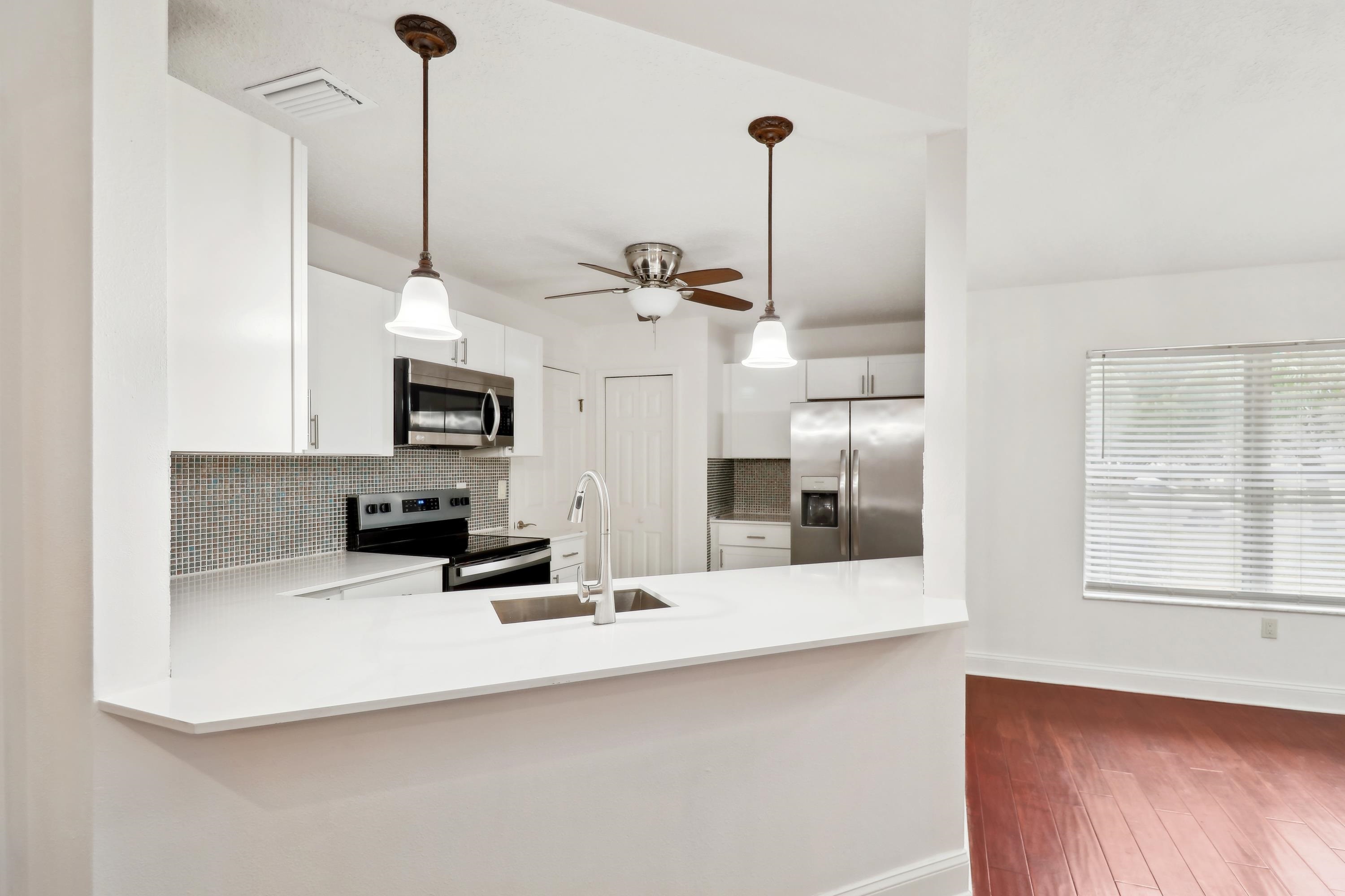 240 Jasmine Road St. Augustine, FL 32086 - Photo 15 of 30 a kitchen with stainless steel appliances kitchen island granite countertop a sink a counter top space and cabinets