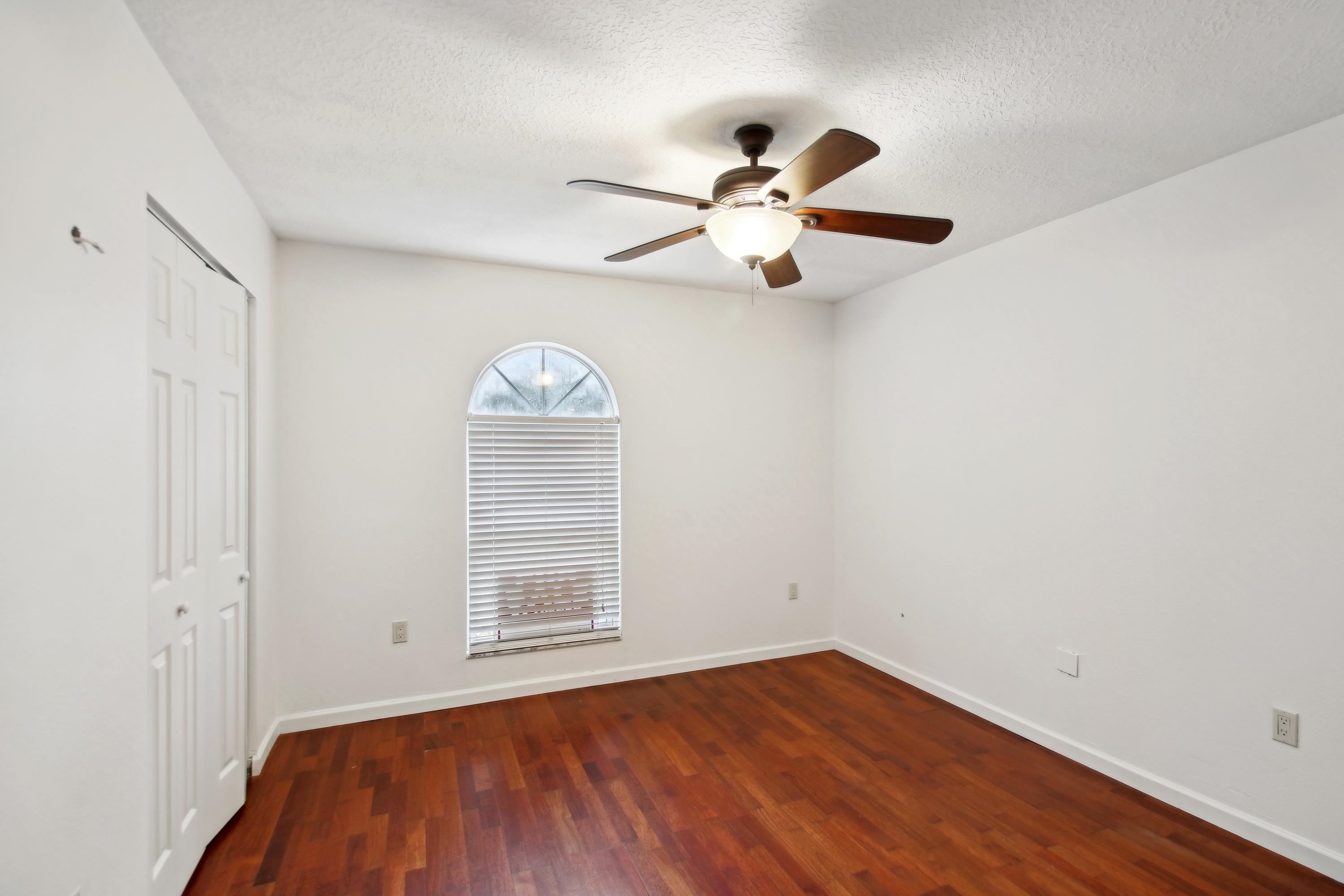 240 Jasmine Road St. Augustine, FL 32086 - Photo 19 of 30 a view of empty room with wooden floor and fan