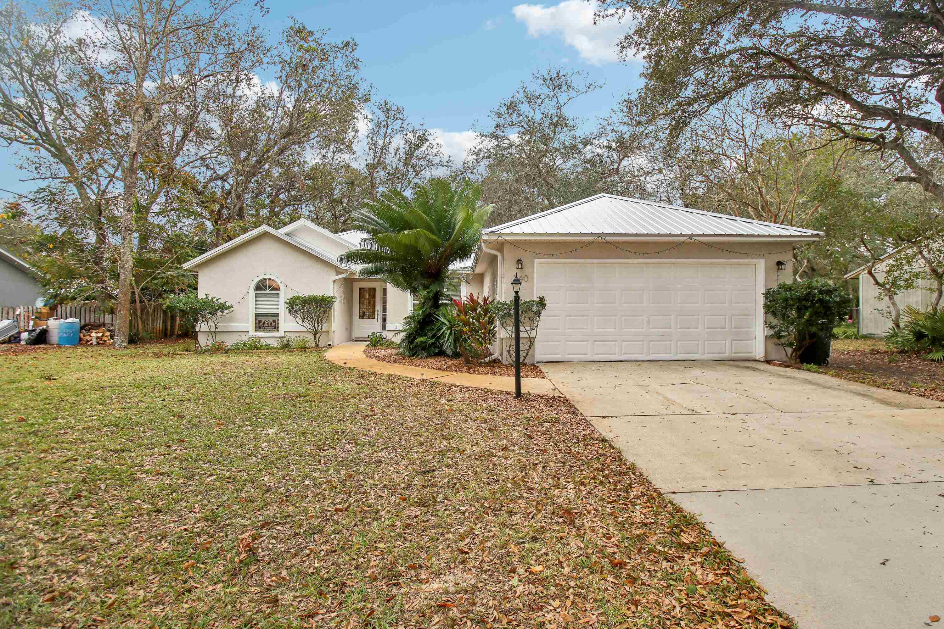 240 Jasmine Road St. Augustine, FL 32086 - Photo 2 of 30 a front view of a house with a yard and garage