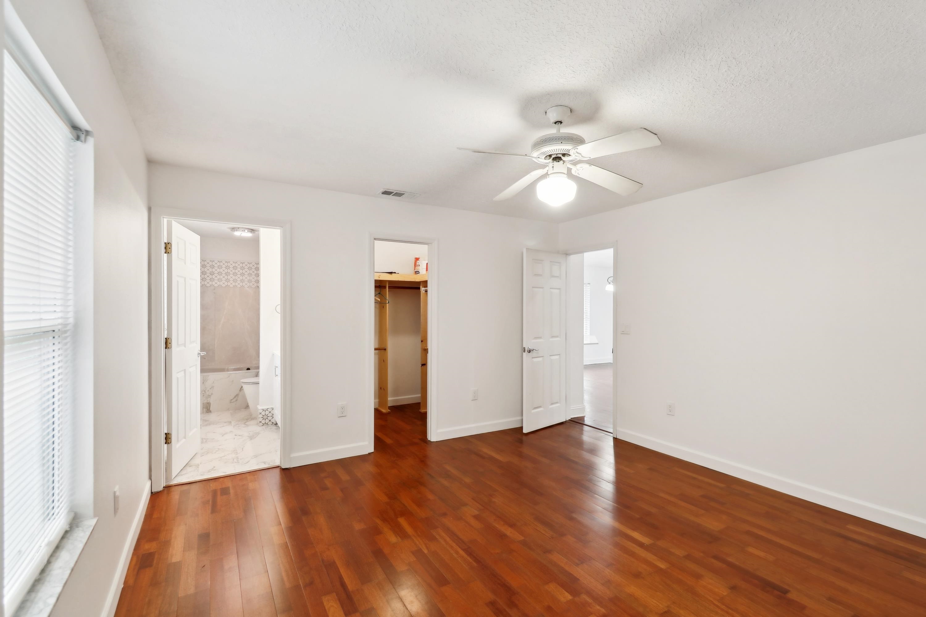 240 Jasmine Road St. Augustine, FL 32086 - Photo 23 of 30 an empty room with wooden floor and ceiling fan
