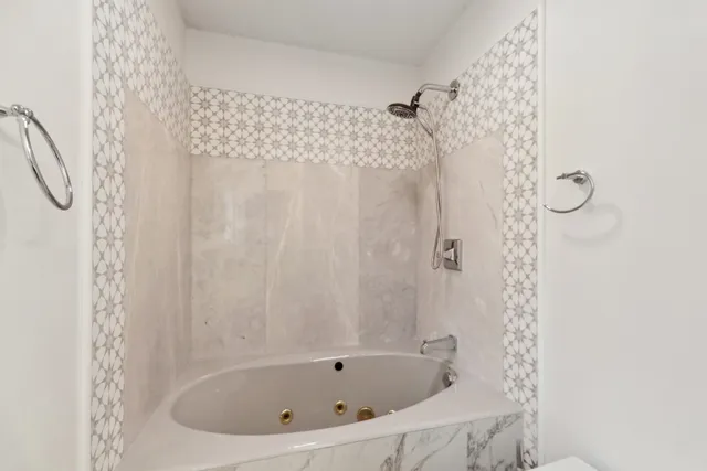 a bathroom with a bathtub and shower