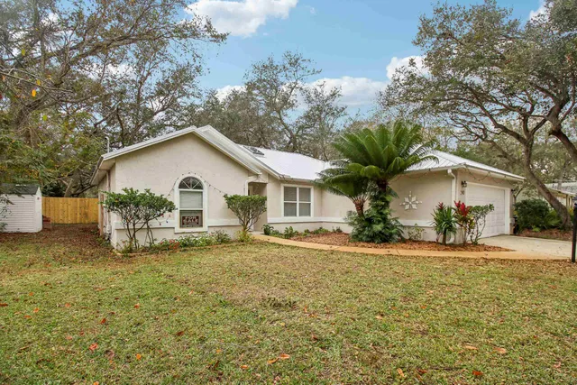 a view of a white house with a yard