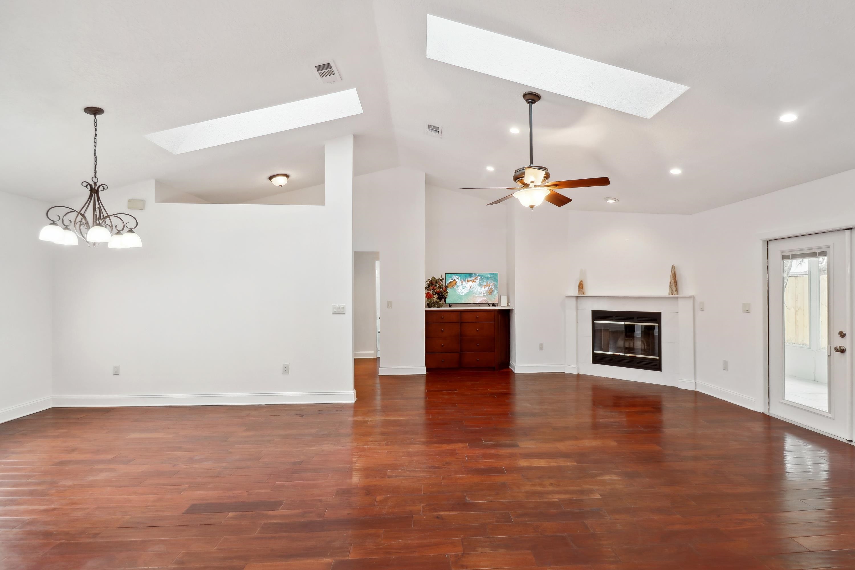 240 Jasmine Road St. Augustine, FL 32086 - Photo 5 of 30 a view of a livingroom with a fireplace a chandelier and wooden floor