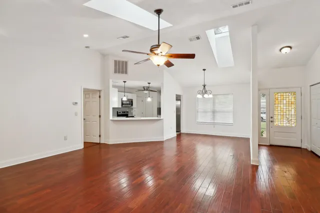 a view of a kitchen with wooden floor and a ceiling fan