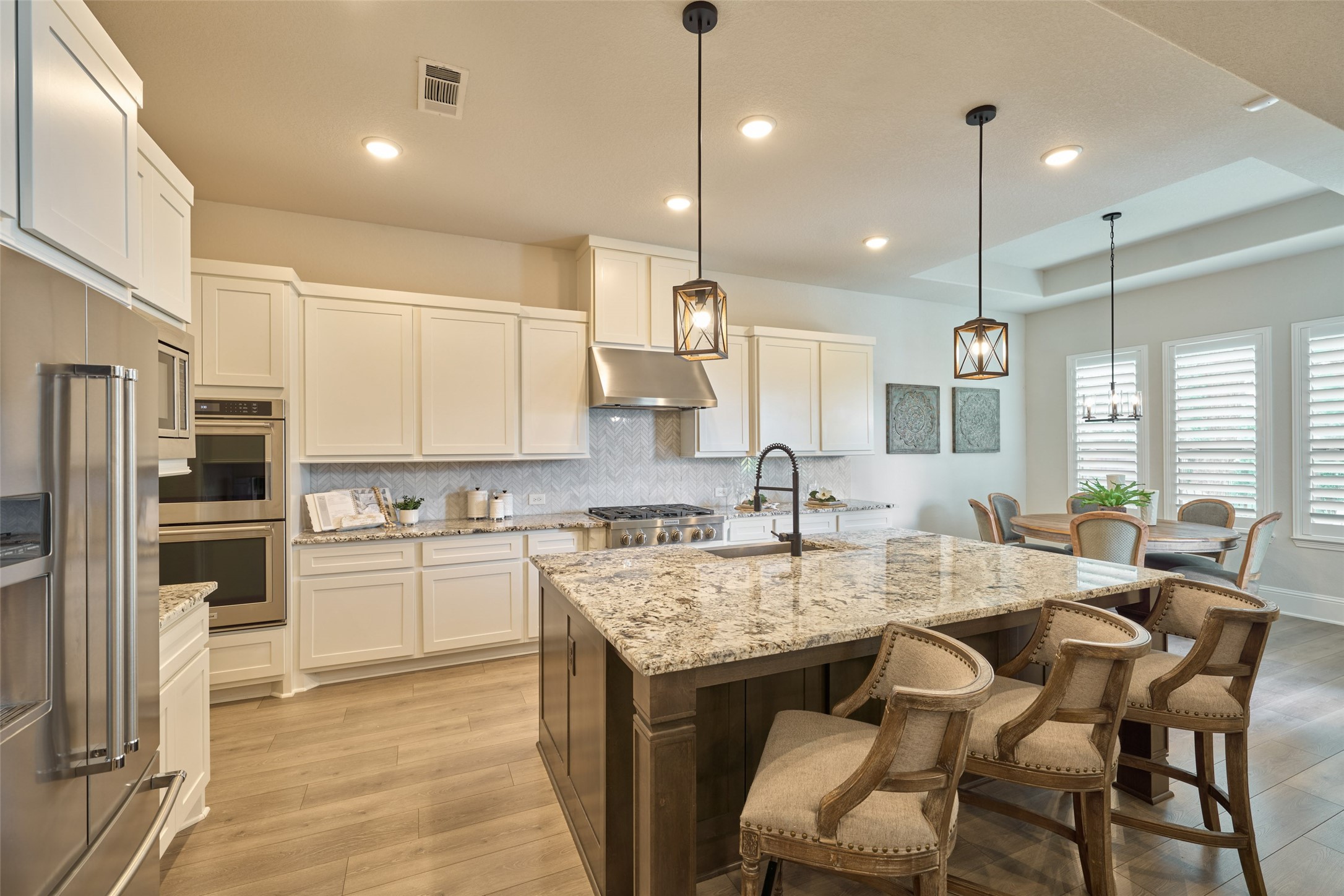 10090 South Goshawk Trail Conroe, TX 77385 - Photo 17 of 43 Kitchen offers center island, granite counter tops, stainless appliances with double oven, gas cooktop, dishwasher and microwave.