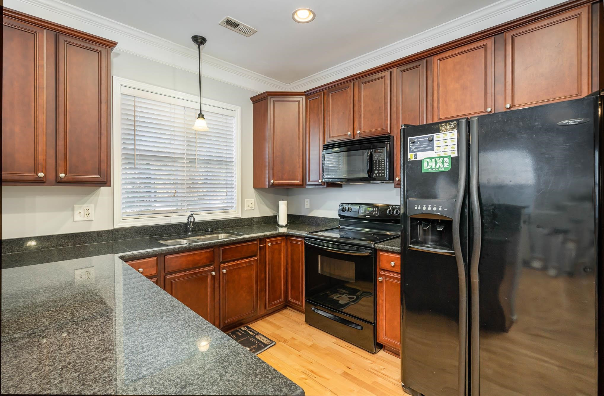 4111 Wyrick Court Raleigh, NC 27604 - Photo 8 of 19 a kitchen with stainless steel appliances granite countertop a sink stove and refrigerator