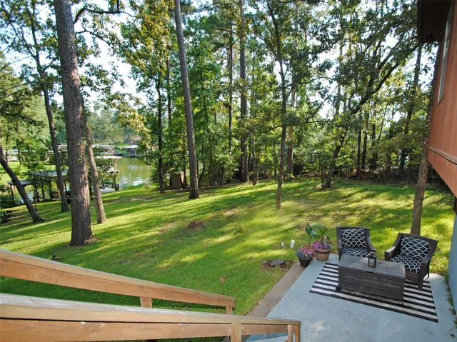 a view of a porch with furniture and garden