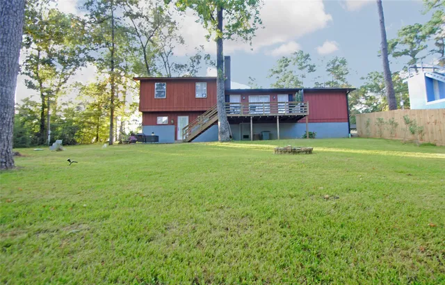 a view of house with backyard outdoor seating and green space