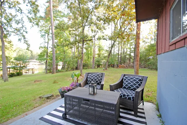 a bed sitting in a spacious bedroom next to a window and a larger closet