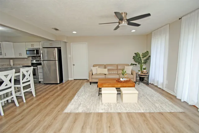 a living room with furniture fireplace and window
