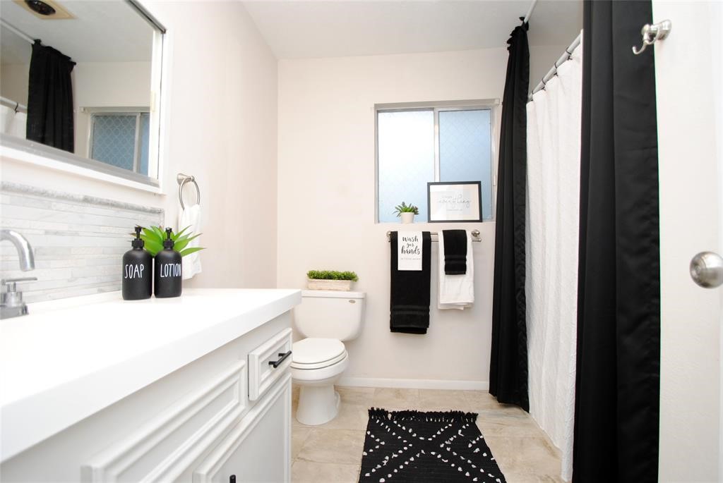 59 Paradise Loop Point Blank, TX 77364 - Photo 7 of 33 a bathroom with a granite countertop sink a toilet and shower