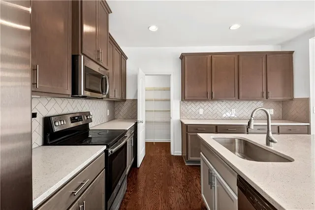 a kitchen that has a sink and a stove top oven