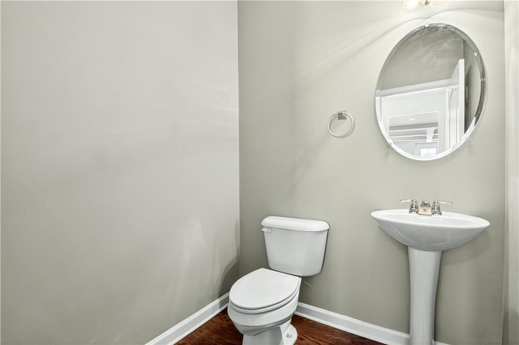 7789 Rutgers Circle Fairburn, GA 30213 - Photo 12 of 39 a bathroom with a toilet sink and mirror