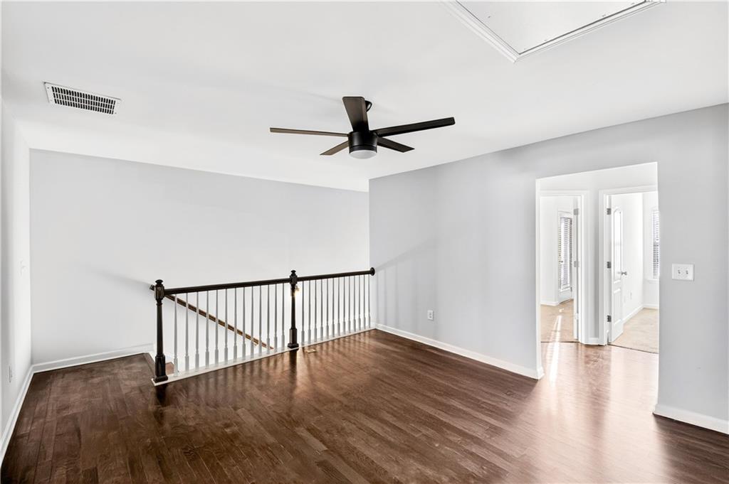 7789 Rutgers Circle Fairburn, GA 30213 - Photo 14 of 39 a view of empty room with wooden floor and fan