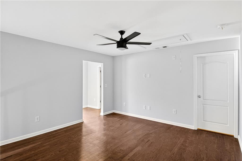 7789 Rutgers Circle Fairburn, GA 30213 - Photo 15 of 39 a view of a room with wooden floor and a ceiling fan