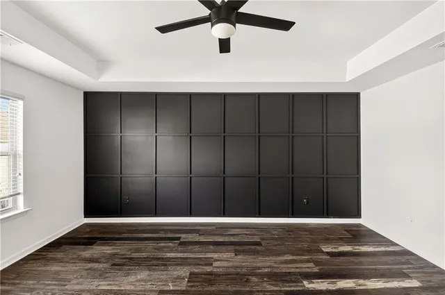 a view of a livingroom with a ceiling fan and window