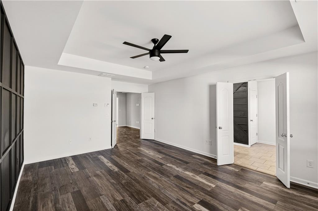 7789 Rutgers Circle Fairburn, GA 30213 - Photo 19 of 39 a view of a livingroom with wooden floor and a ceiling fan