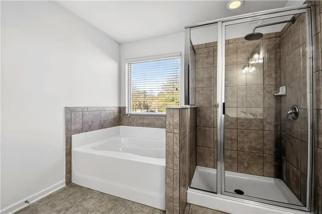 a bathroom with a bathtub and a shower