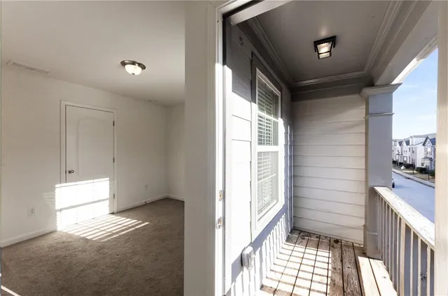 a view of hallway with wooden floor and cabinet