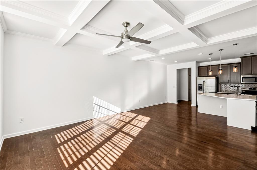 7789 Rutgers Circle Fairburn, GA 30213 - Photo 6 of 39 a view of an empty room and kitchen with wooden floor