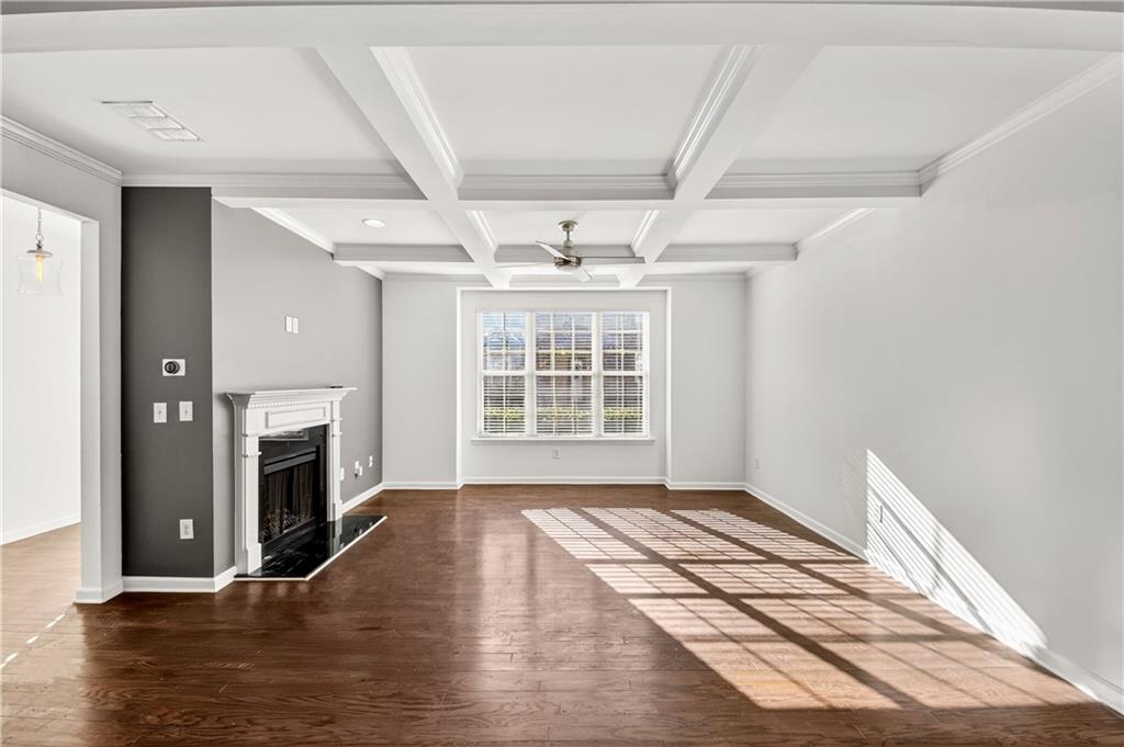 7789 Rutgers Circle Fairburn, GA 30213 - Photo 8 of 39 a view of an empty room with wooden floor and a window