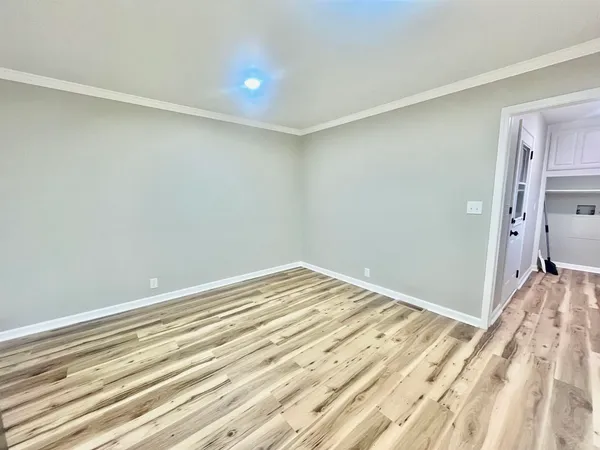 a view of a room with wooden floor and bedroom