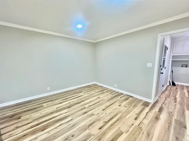 a view of a room with wooden floor and bedroom
